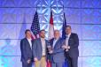 John Picking, (2nd from L) dealer principal of Ballard Truck Center, and Rob Picking (3rd from L), director of operations of Ballard Truck Center accept the award for Volvo Trucks North America 2022 U.S. Dealer Group of the Year from Peter Voorhoeve (R), president, Volvo Trucks North America and Chris Gossler, regional vice president — Northeast, Volvo Trucks North America. 