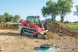 With a Takeuchi TL12V2 compact track loader, an operator moves dirt. 
(Kirby-Smith photo) 