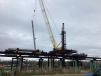 A crane lifts a 30-in. by 85-ft. precast concrete pile bottom section at bent 2C-20.
(ECM Consultants photo)
