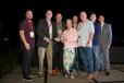 Jennifer Nix (C) of Shelby Erectors receives the Project of the Year award from Bob Beckner, Project of the Year Moderator, and is surrounded by members of the Shelby Erectors team and SEAA representatives.  