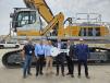 Tim Kraut, president and CEO of American State Equipment (C), presents the key for the Liebherr LH110 material handler to (L-R) Pete Colangelo, vice president of terminal operations, Middle River Marine; Aaron Halcomb, president of Middle River Marine; Marty Ozinga, CEO of Ozinga Ventures; Aaron Ozinga, president of Ozinga Ventures; and Todd Johnson, regional sales manager of Liebherr USA.
(CEG photo) 