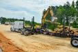 A SANY excavator loads this trailer with tree trunks from land clearing operations.
(NCDOT photo) 