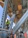 Ironworkers are using a combination of electric and mechanical chainfalls to position truss strengthening plate into position.
(Aetna Bridge photo) 