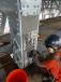 Ironworkers drill and install a vertical chord strengthening plate.
(Aetna Bridge photo) 