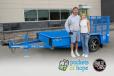Joe Kostreba, auction winner, and Brenda Jennissen, Felling Trailers’ CEO with the 2023 Trailer for a Cause, a FT-3 utility trailer. 