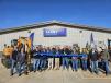 Steve Luby (C), president of Luby Equipment, cuts the ribbon to officially open the new Fairmont City, Ill., location with David Kedney (left of Luby), executive vice president; Doug Juergensen (right of Luby), vice president and COO; and the rest of the Luby Equipment team.
(CEG photo) 