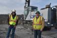 Tony Moura (L) and Lee Baldwin, both managing partners of Tri-State Drilling and Blasting, with a Furukawa rock drill.   (CEG photo)