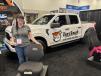 Amanda Slingsby of Tiger Tough of Mankato, Minn., introduces Ironweave construction equipment seat protectors at the Work Truck Show. “These seat covers offer heavy duty, waterproof protection for all your construction equipment investments,” said Slingsby.   (CEG photo)