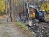The crew from soil and water begins to place stone in the stream for erosion control.   (photo courtesy of the town of Urbana highway department)