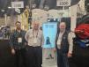 At the Astec Industries booth, (L-R) are Marc-André Séguin of Pavages Maska of Quebec, Canada; Eric Couture of Pavages Maska; and Maxime Petrin of Montreal Tracteur of Quebec, Canada, stand in front of the Roadtec RX-405 cold planer, which features an operator camera awareness system with a 360-degree operator view.
   (CEG photo)