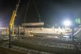 Crews lower a steel beam into place on a bridge over Interstate 17 in Arizona.   (Arizona Department of Transportation photo)