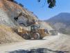 A Cat 982M wheel loader and a Cat 390D excavator work together to clear space for a new bridge alignment.
   (Caltrans photo)