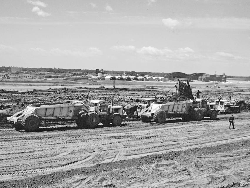 Edgar Browning Collection photo
Another view of one of the Euclid BV loaders filling bottom dumps. A Caterpillar D8 tractor is pushing the belt loader to boost production rates.