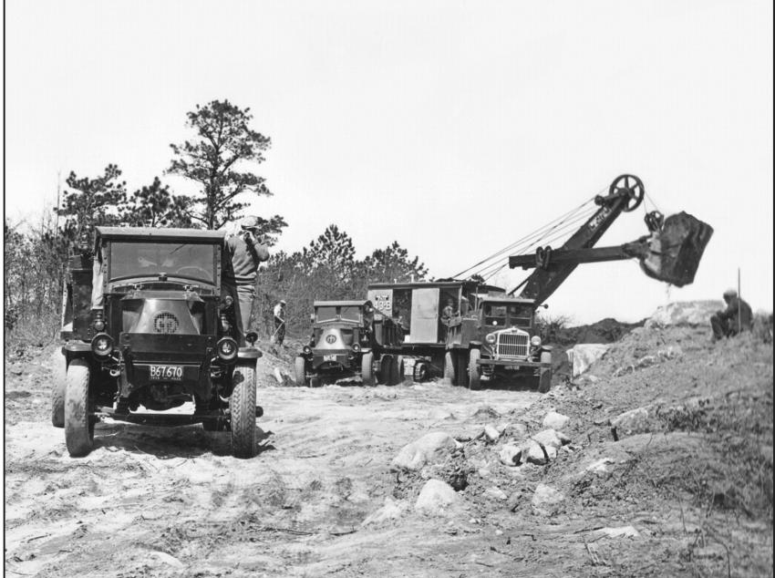 National Archive photo - Arute Bros. Inc. of Bridgewater, Mass., held the contract for the relocation of the highway on the south side of canal made necessary by the canal widening project. Arute is using a Bucyrus- Erie 43-B shovel with a 1-3?4 cu. yd. (1.34 cu m) dipper to load heavy duty Mack AC and Sterling chain drive dump trucks. The photo was taken on May 1, 1935.