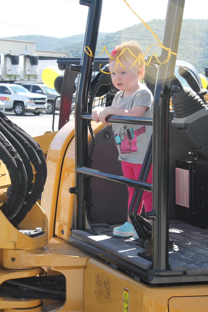 Two-year-old Wade Sparks and his twin sister, Charlotte, test the Cat 305.5E mini excavator. Their parents, Leslie and Yancey Sparks, own a farm in Sparta, N.C. 