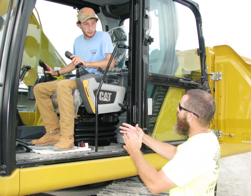 Discussing the new Cat 320 excavator are Cameron Collins (in cab) and Eric Collins of Collins Site Services, which is an earthmoving contractors, based in Senoia, Ga.
