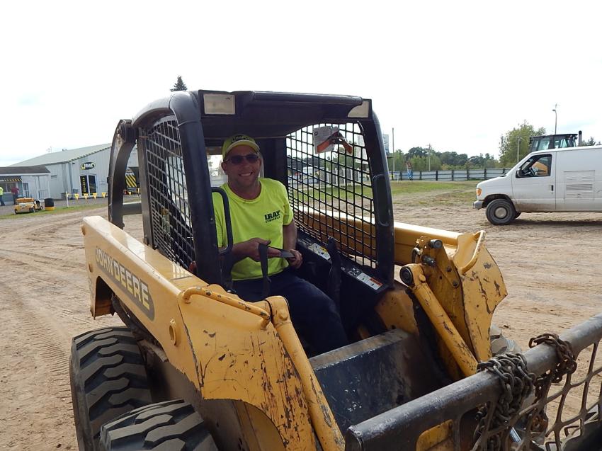 Longtime IRAY lot equipment driver Joe Nelson moves sold equipment for buyers with his John Deere 250 skid steer.
