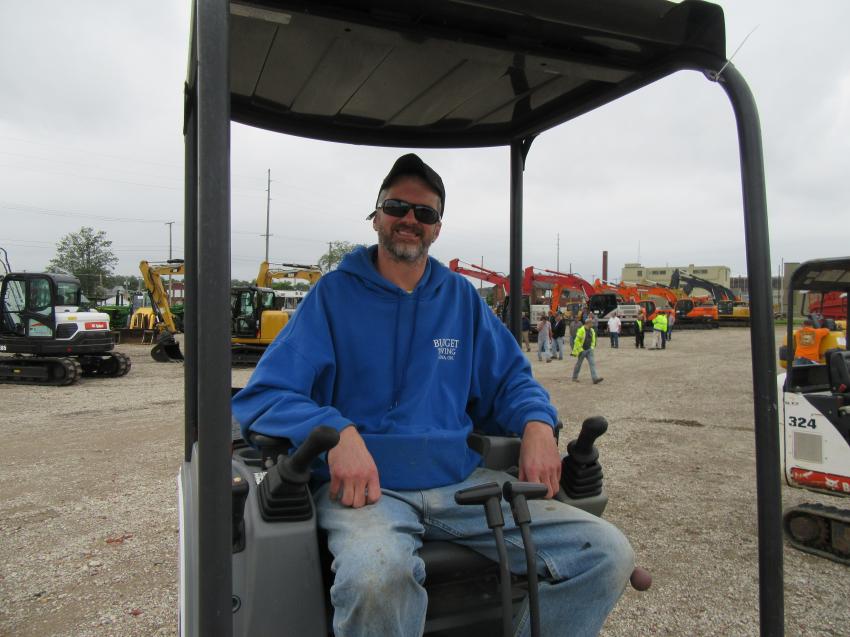 Brian Kress of Budget Towing tries out a Bobcat E20 mini-excavator. 
