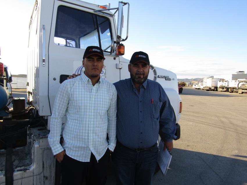 Heber (L) and his dad, Ignacio Ochoa, traveled all the way from Chihuahua City, Mexico. They were looking for a number of pieces they will transport to Mexico for resale. This 1995 Ford asphalt truck is one of several they bid on.
