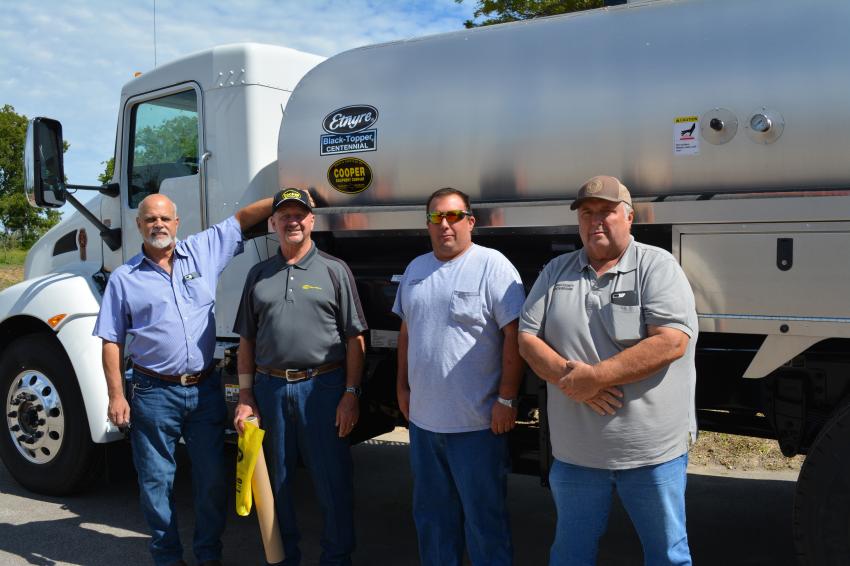 (L-R): George Cooper, president of Cooper Equipment, and Rick Chapman, branch manager of Cooper Equipment, greet Llano County employees Kody Wagner and Richard Wooten. Wagner and Wooten were looking for information on this Etnyre Black-Topper Centennial asphalt distributor.
