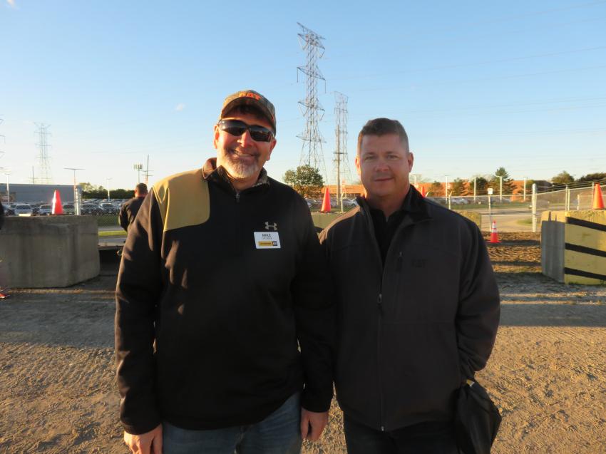 Mike Grubbs (L) of Altorfer CAT shows Jim Hager of Hager Excavating around the demo area at Iron Night in Elmhurst, Ill. 
