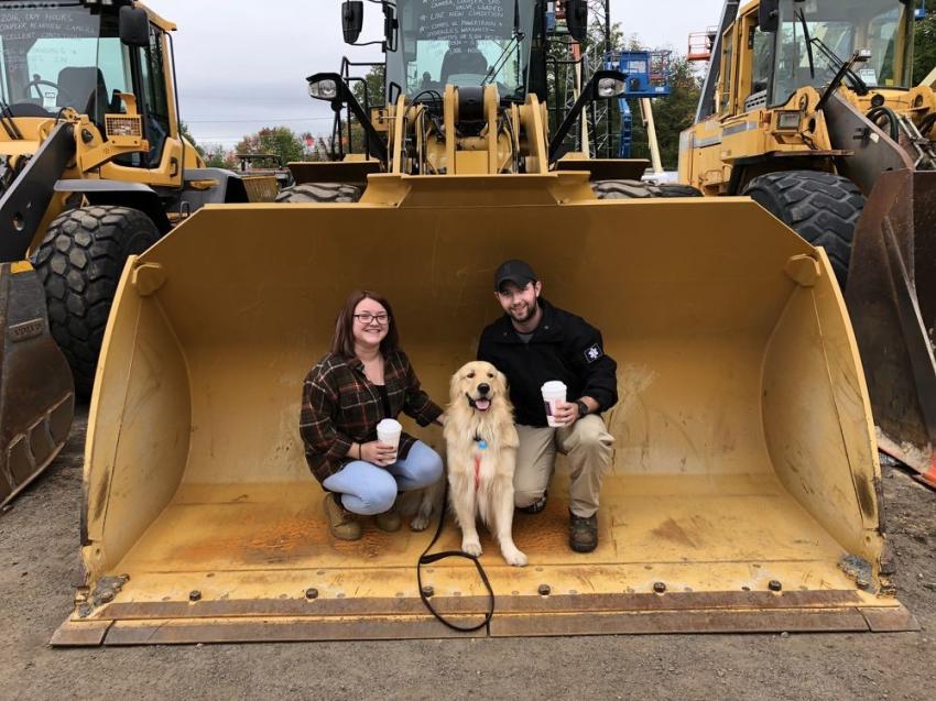 Get a load of this Cat 950M that sold for $190,000. Emily Csuka and Tom Cobb of Evergreen Tree Services enjoy the sale accompanied by their dog, Timber.