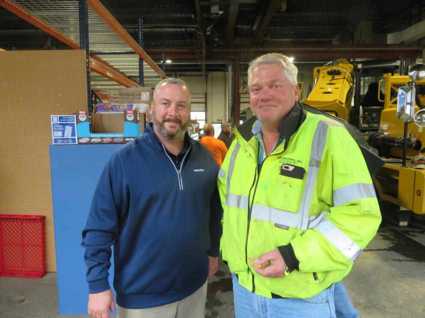 Dan Smith (L), Roland Machinery Co.’s vice president and general manager, product support, meets with Scott Halverson, president of Halverson Construction.
