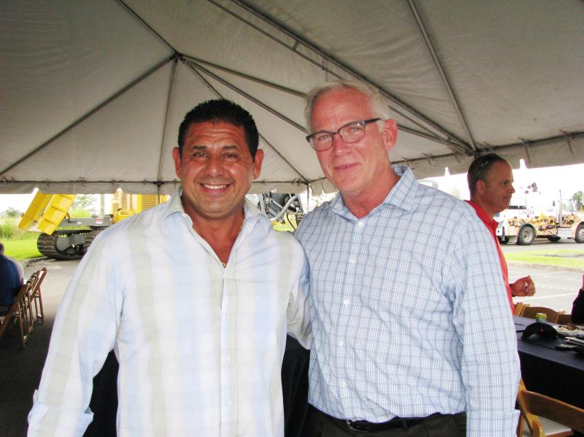 Linder Industrial Machinery President John Coughlin (R) gives a warm welcome to Carlos Aldarado of C&R Milling & Paving of Miami, his friend and customer of many years, at the Pembroke Pines open house. 
