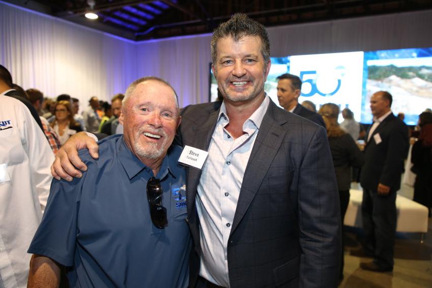 Denny Anderson (L), superintendent of Sukut Construction, and Steve Yurosek, president of Sukut Construction, celebrate the company’s 50th anniversary.  
