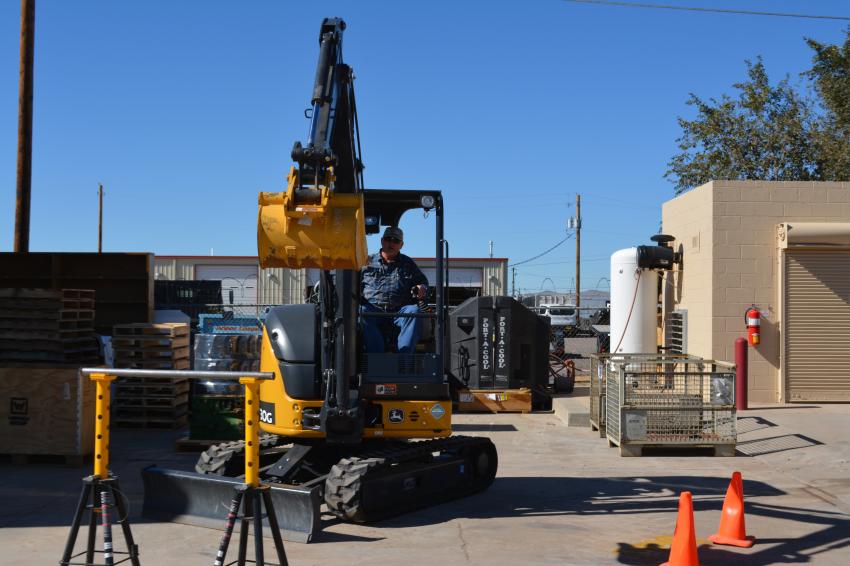 Todd Fergus, project manager of EMCO of Santa Fe, shows his prowess maneuvering a John Deere compact excavator in one of the many contests 4Rivers had for customers at its open house.
