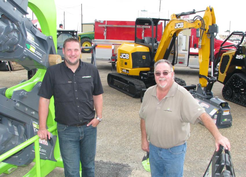 Blake Eavenson (L) and Bill Schafer of Loftness Mfg., Hector, Minn., had a nice selection of ag and construction attachments in their display area.