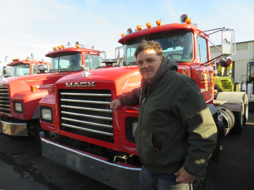 Bruce Kordas, owner of Kordas Inc., in front of one of his Mack trucks prior to the start of the sale.
