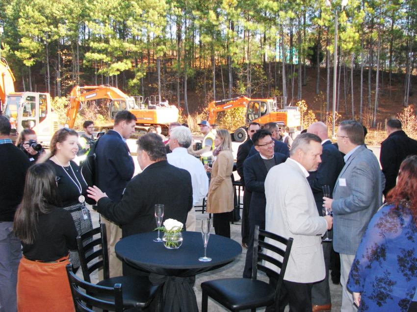 Doosan staff, dealers and guests socialize after the ribbon cutting.  
