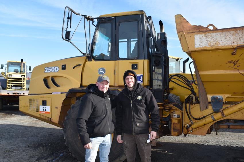 Richard Wojtkowski (L), owner of Pittsfield Lawn and Tractor and his son, Chase, take a look at a Volvo articulated hauler.