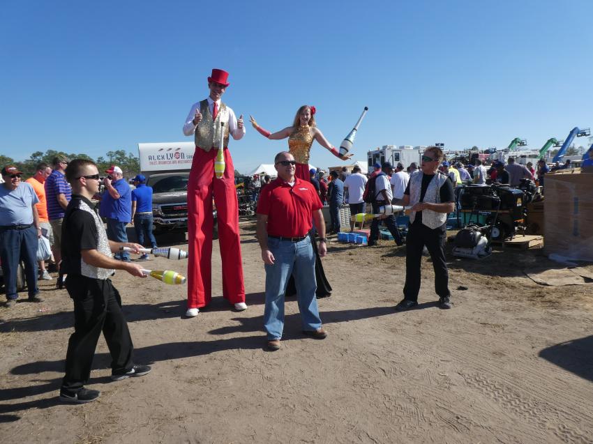 You never know from year to year 
what entertainment Jack Lyon will provide
 at the annual Kissimmee auction.  Construction Equipment Guide’s Southeast Sales Representative Rich Olivier (C) became part of the act and we can
 report was not hit by a juggler. 
