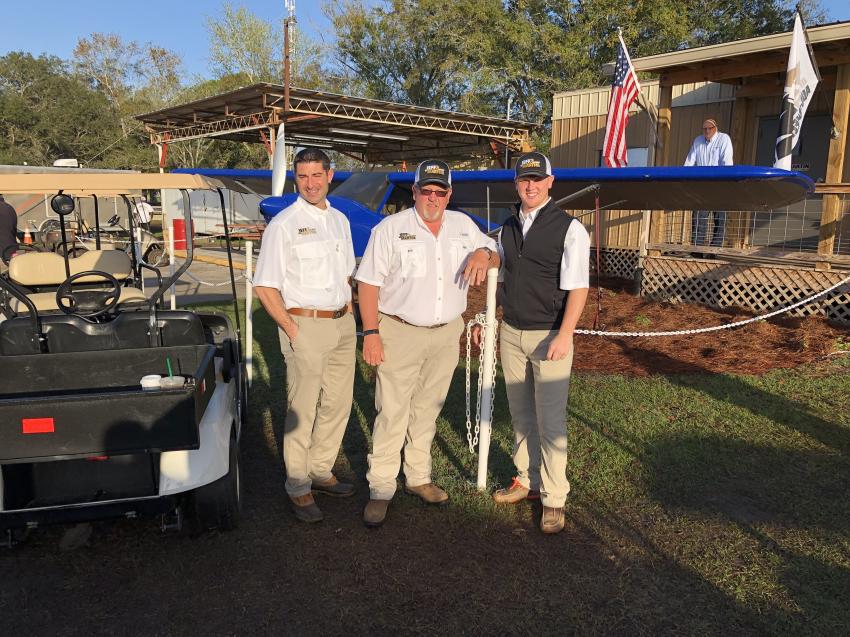 (L-R): Trey Morris, Jeff Martin and Jeff Garber, all of Jeff Martin Auctioneers, stand in front of a 2009 Carbon Club Crafters airplane that was sold on Feb. 12.