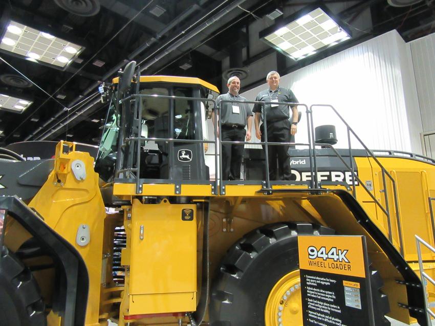 Bill Staidl (L) and Tom Porter of John Deere Construction & Forestry Company spoke with attendees about the company’s largest wheel loader, the 944K, which has a 10 cu yd. bucket capacity. 
