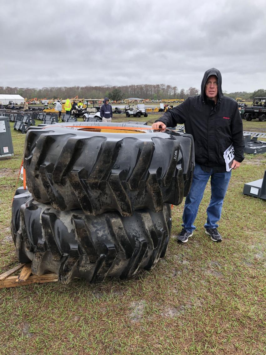 Tim Schipper of EXP Equipment Wholesalers, Mears, Mich., inspects a few tires that suited his needs and he planned to bid on them.
