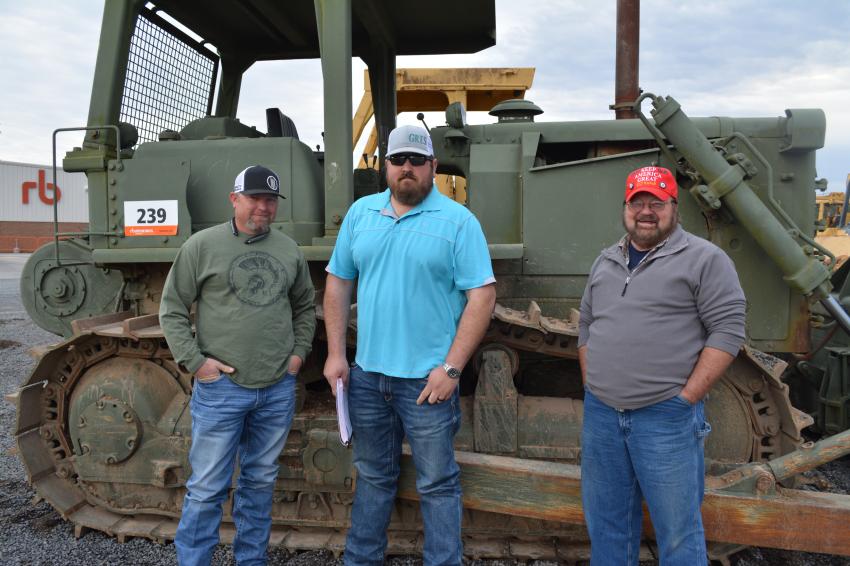 The Longview, Texas, contingent includes (L-R): Josh Milner of Milner Consultants; Devin Gentry of Gentry Transport; and Harold Wilson of Tri-W Global. The trio are closely inspecting this vintage Cat D7F crawler dozer that was up for sale.
