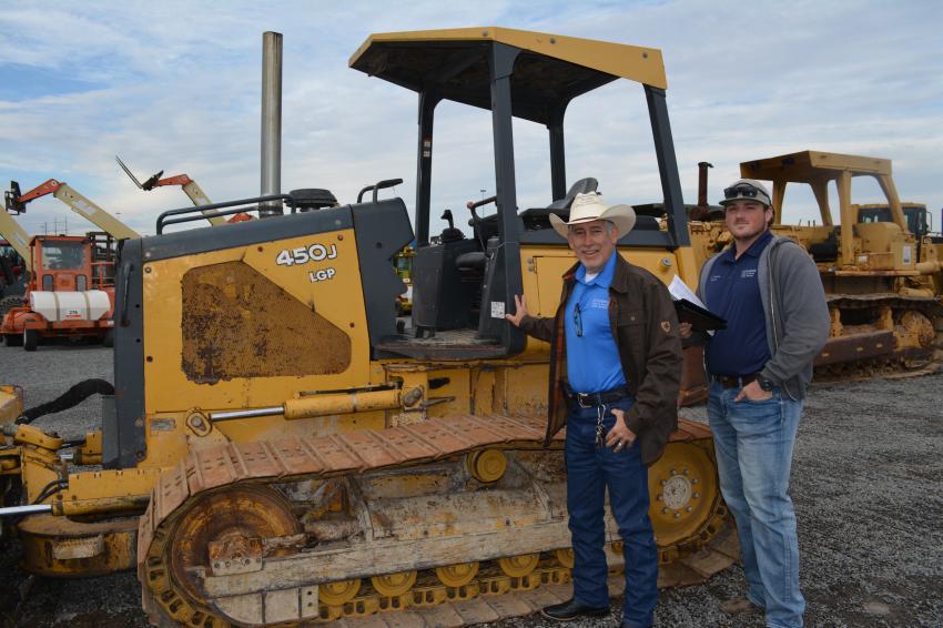 Freddie Gonzales (L), owner of Affordable Sand and Gravel in Hempstead, Texas, wants to add a dozer to his company’s fleet and took a long look at this Deere 450J. Chad Johnson, also of Affordable Sand and Gravel, is along to help.  
