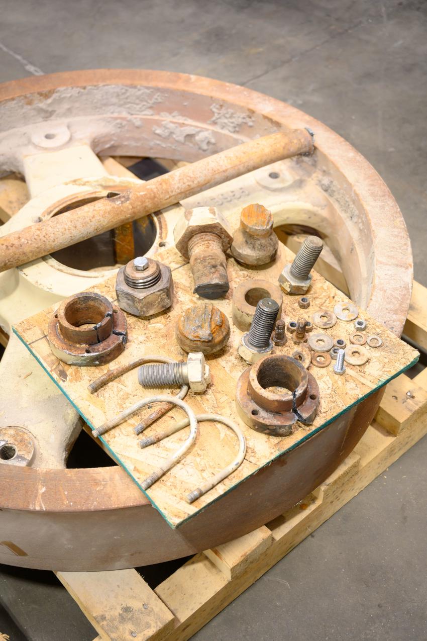 Parts from an LT106 fly wheel and hydraulic pump on display to show examples of what to look for with machine maintenance and production issues.