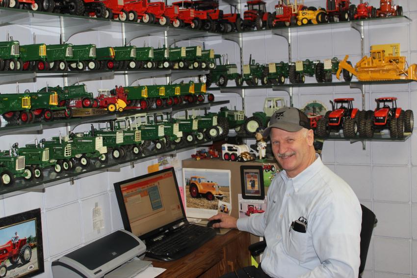 Paul Lano, sales manager, displays an extensive collection of miniature equipment in his office.  
