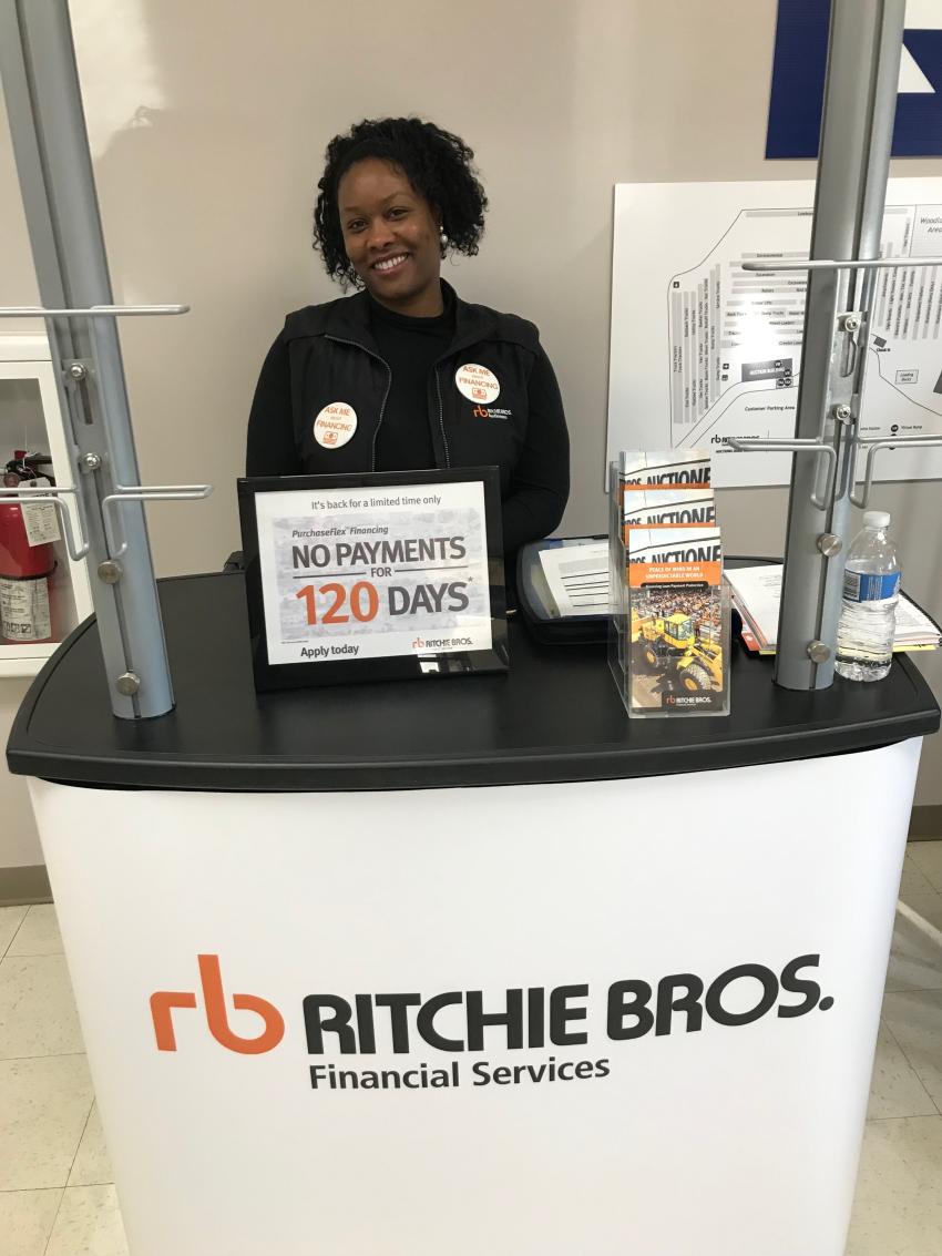 Shira Bethea is all smiles handling duties at the Ritchie Bros. Financial Services booth.
