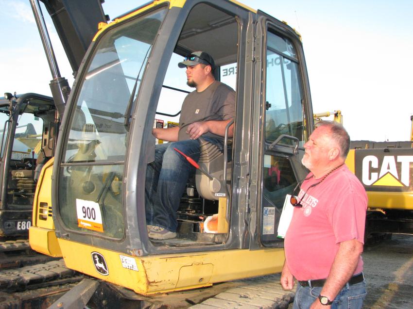 Putting a John Deere 75D mini-excavator to the test are Kenny Bryant (L) and his dad, Gary Bryant, of Gary Bryant Enterprises Inc., Burnsville, N.C. 
