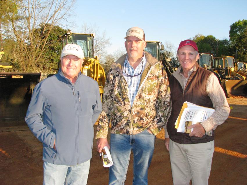 (L-R): Chris Pate, Sink Creek Preserve, Alpha, Fla.; Jeff O’Bryan, Longleaf Timber Products, Bristol, Fla.; and Jerry Pate, Jerry Pate Co., Pensacola, Fla., have an early-morning discussion on the construction equipment offered on day three of the four-day sale.
