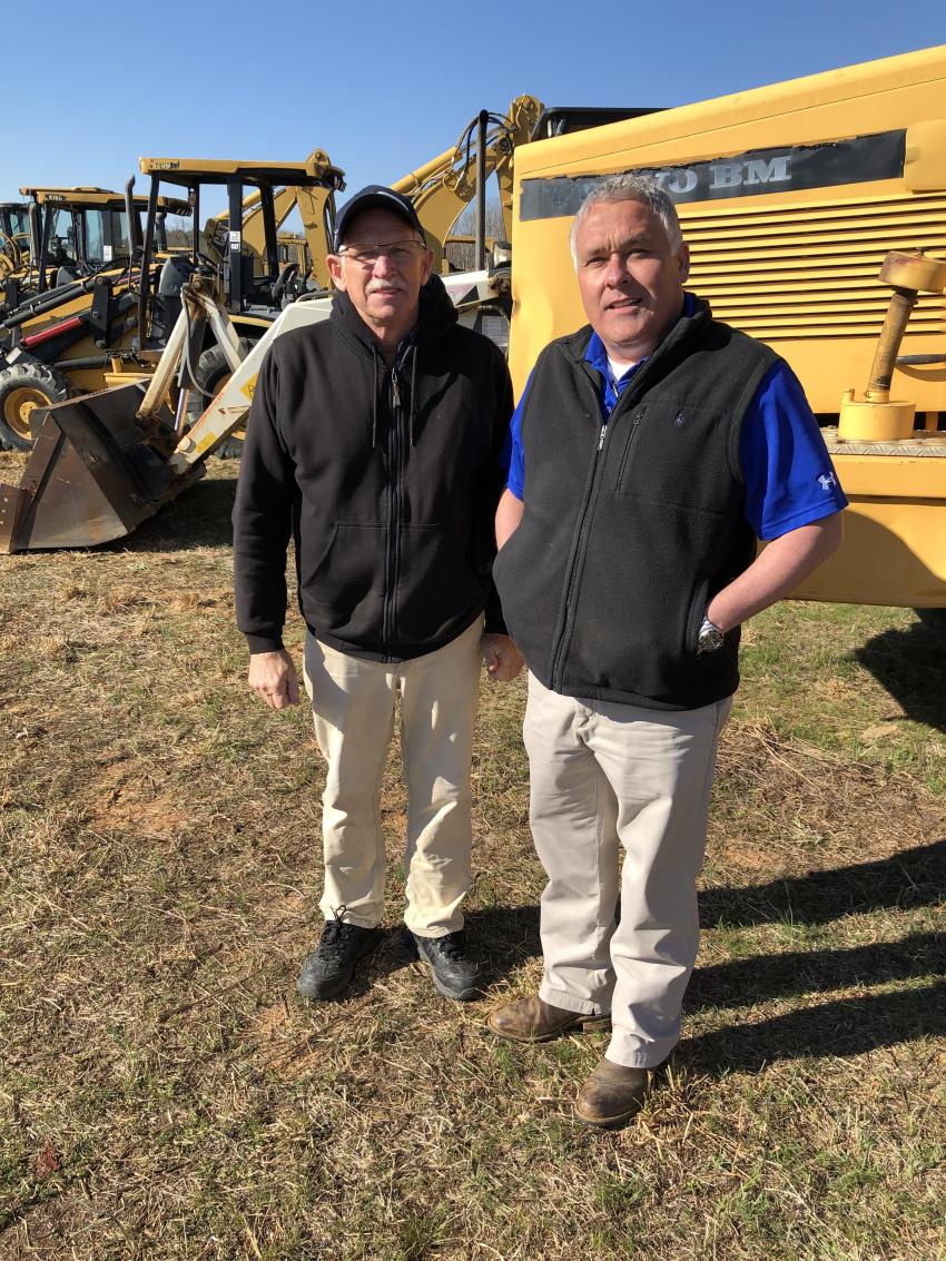 Ronnie Smith (L) of R.L. Smith Inc. in Mooresville, N.C., goes over a few last-minute items with Matt McGaffee of Iron Auction Group.
