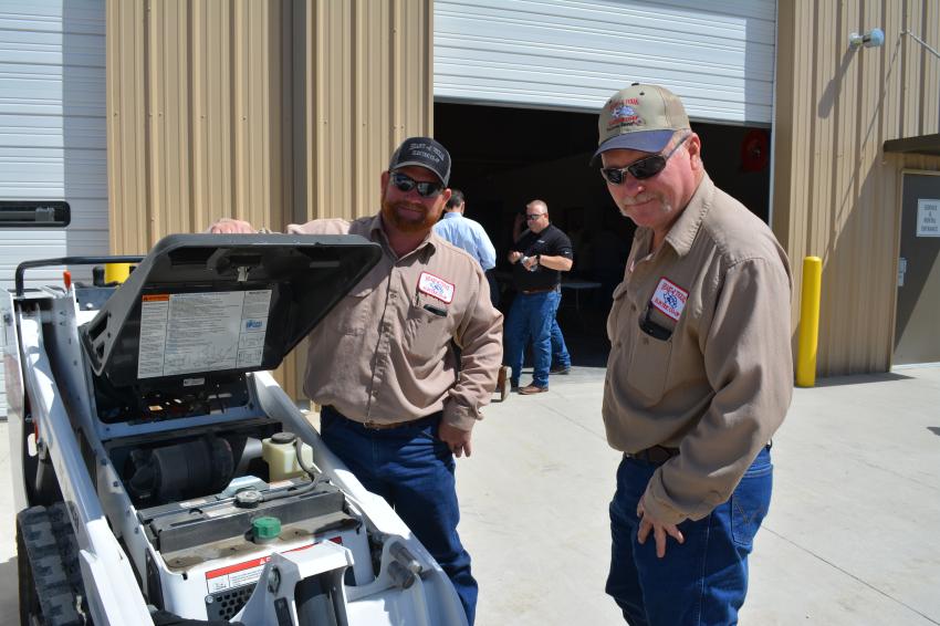 Keith Schwake (L) and Randy Westerfield of Heart of Texas Electric Cooperative check out the Bobcat MT85 before enjoying lunch.
