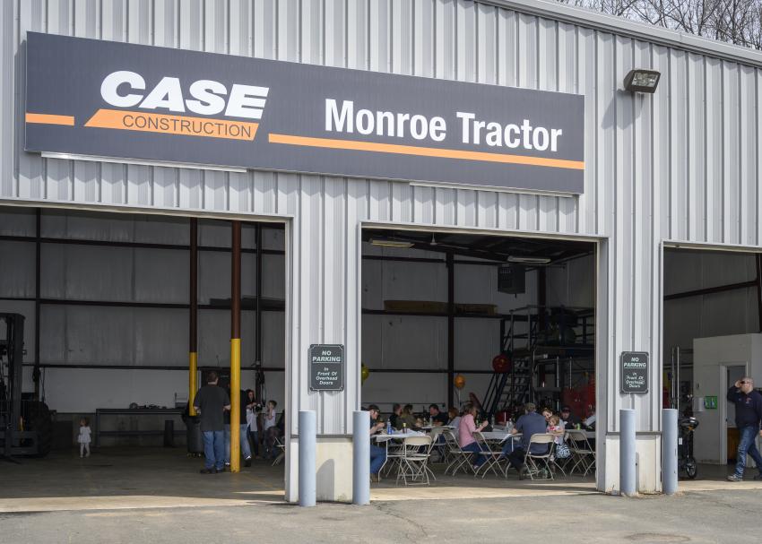 Attendees of Monroe Tractor’s grand opening event on April 13, 2019, enjoy lunch in the four bays of its new location in South Windsor, Conn.