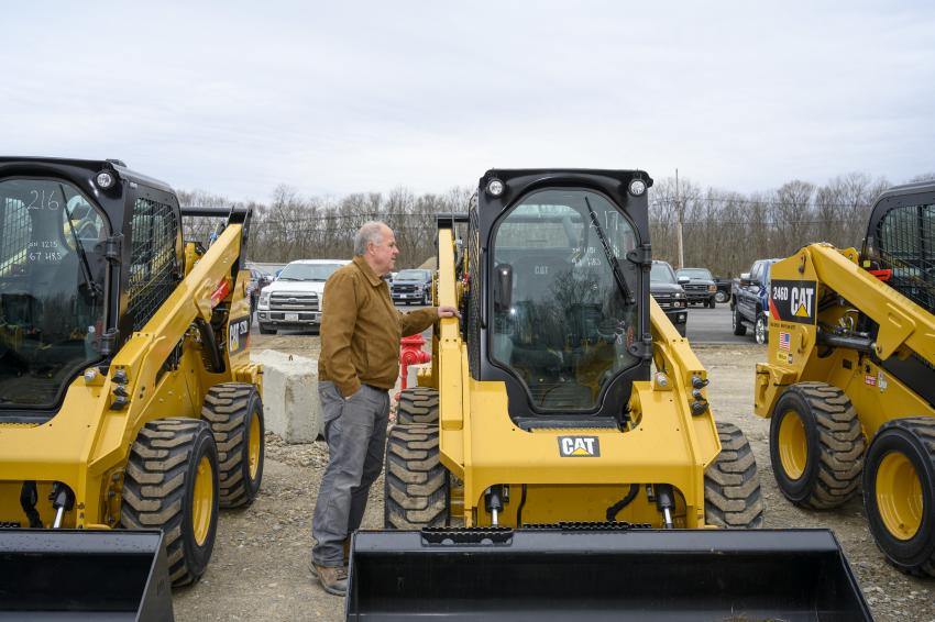 David Elbery of Elbery Motor Company in Natick, Mass., checks out one of the many Caterpillar skid steers ready to be auctioned off.