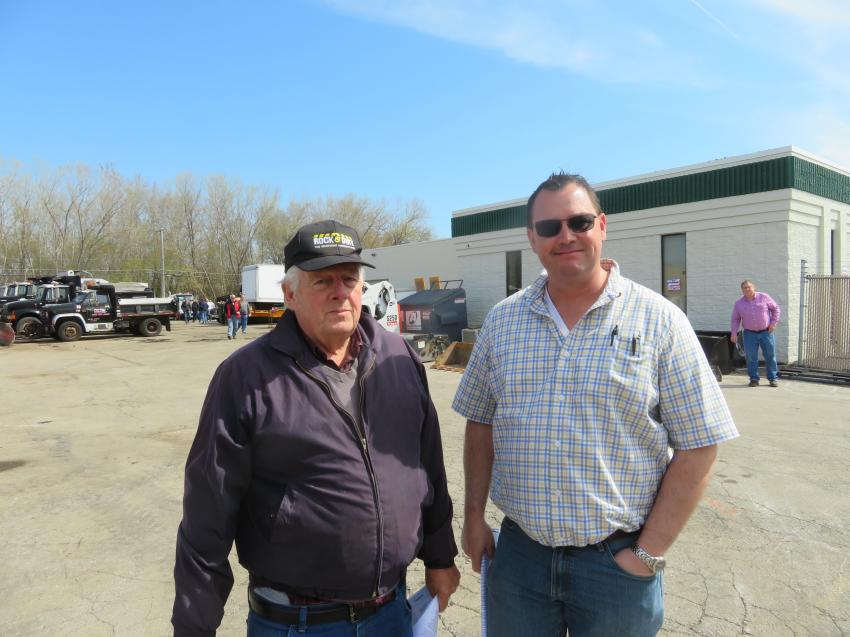 Les Hull (L), owner of Hull’s 151 Implement, and Mike Lambert of M&D Equipment Sales compare notes prior to the start of the sale.
